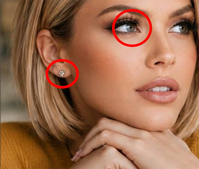 Close up of the original face with the earring and eye circled in red to compare details